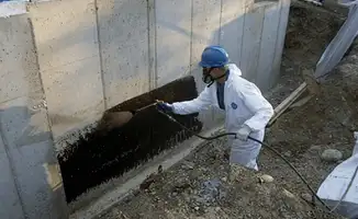 Professional waterproofing the exterior walls of the basement in San Diego, CA